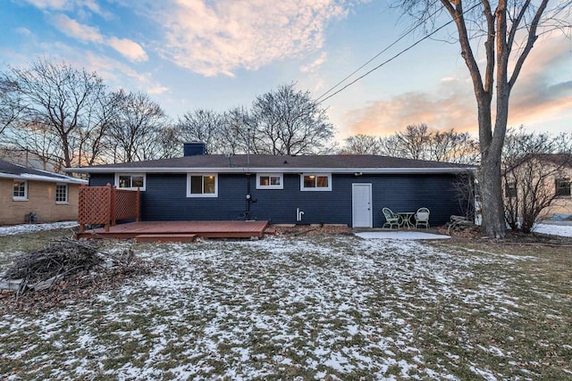 snow covered property with a deck