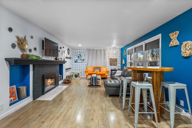 living room with a fireplace and light hardwood / wood-style floors