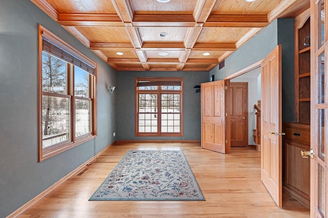 entryway featuring light hardwood / wood-style flooring, a wealth of natural light, coffered ceiling, and beamed ceiling