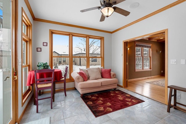 interior space featuring ceiling fan, ornamental molding, and a healthy amount of sunlight