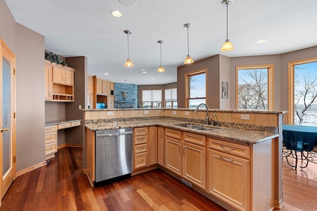 kitchen featuring a healthy amount of sunlight, pendant lighting, stainless steel dishwasher, and sink