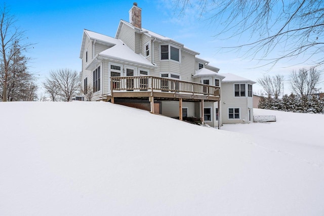 snow covered property with a deck