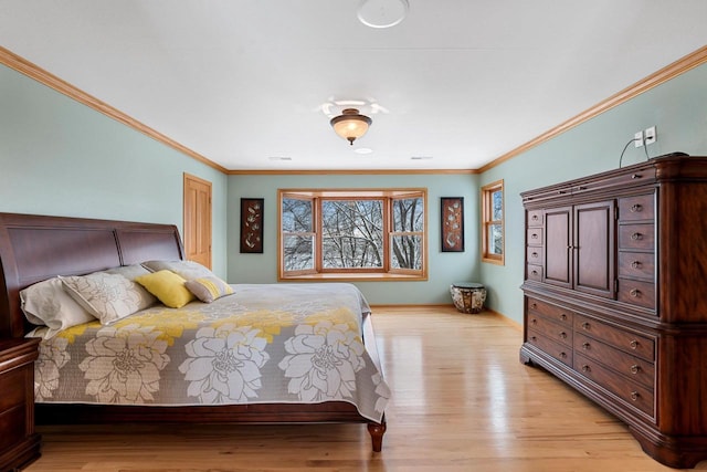 bedroom with ornamental molding and light hardwood / wood-style floors