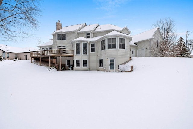 snow covered property featuring a deck