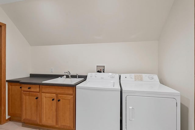 laundry room with washer and clothes dryer, sink, light tile patterned floors, and cabinets