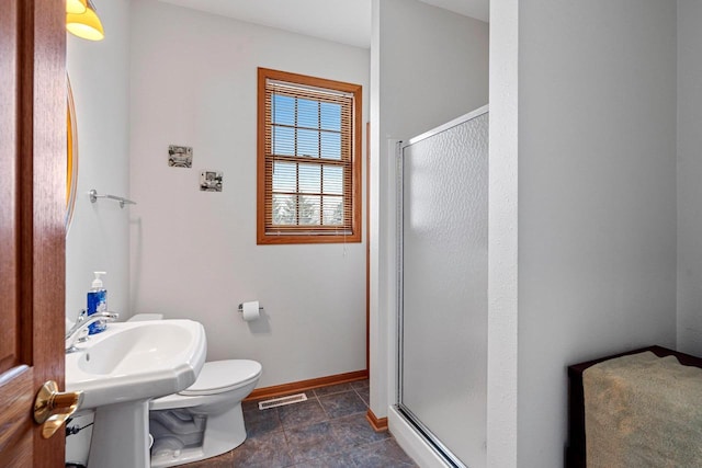 bathroom with walk in shower and toilet