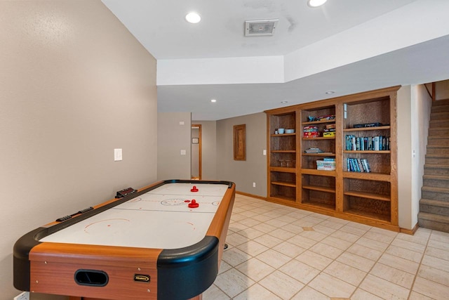 recreation room featuring built in shelves