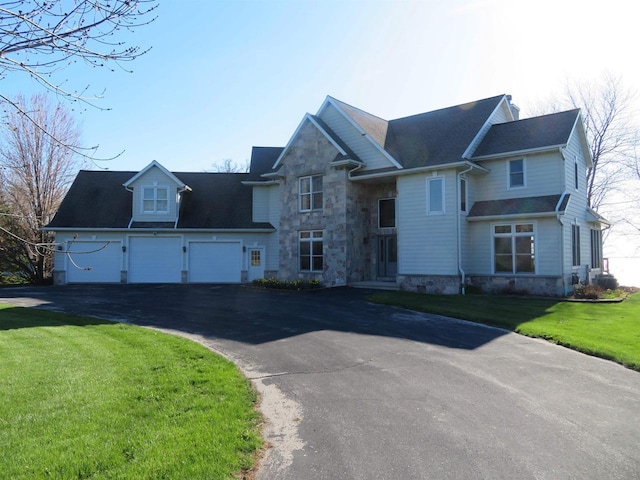 view of front of house with a front yard and a garage