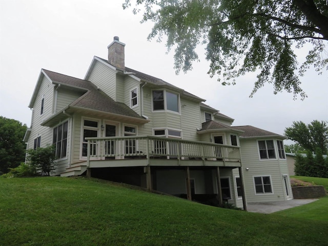 rear view of house with a wooden deck and a yard