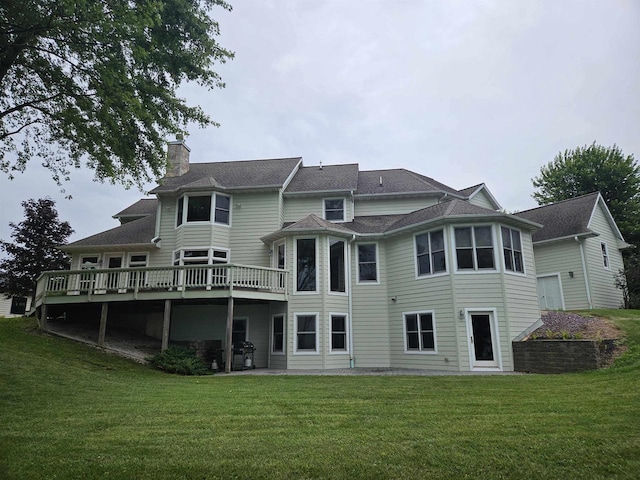 back of house with a lawn and a deck