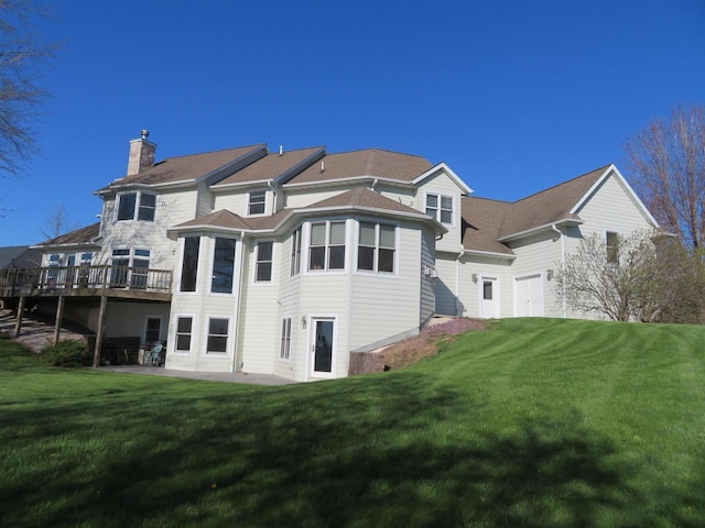 back of property featuring a deck and a yard