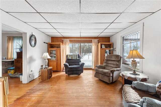 living room featuring hardwood / wood-style flooring and a drop ceiling