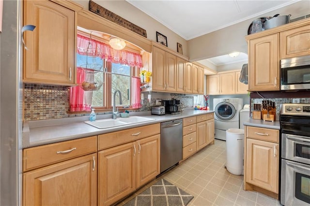 kitchen featuring appliances with stainless steel finishes, tasteful backsplash, light brown cabinetry, independent washer and dryer, and sink