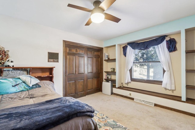 bedroom featuring ceiling fan, a closet, and carpet flooring