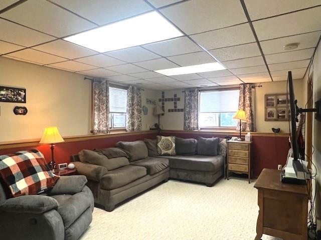 living room with a paneled ceiling