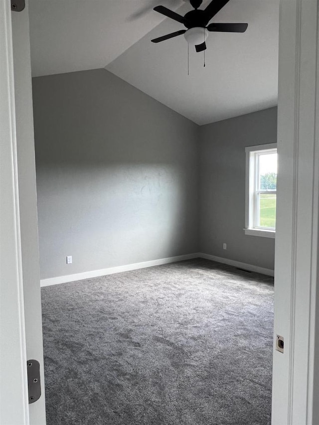 empty room with carpet floors, lofted ceiling, and ceiling fan