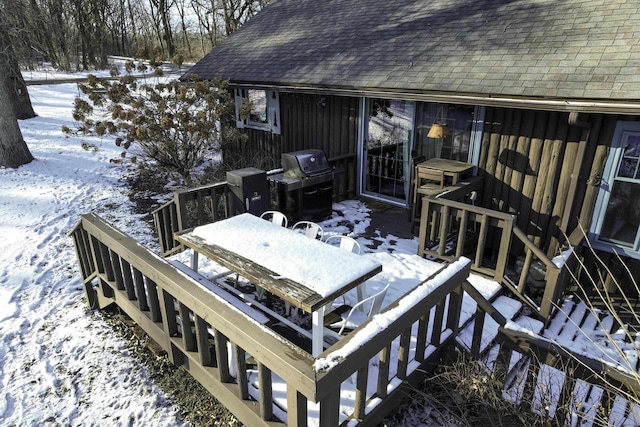 snow covered deck featuring a grill