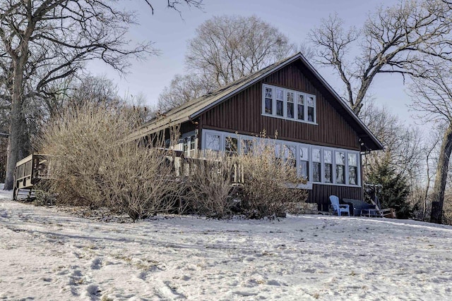 view of snow covered back of property