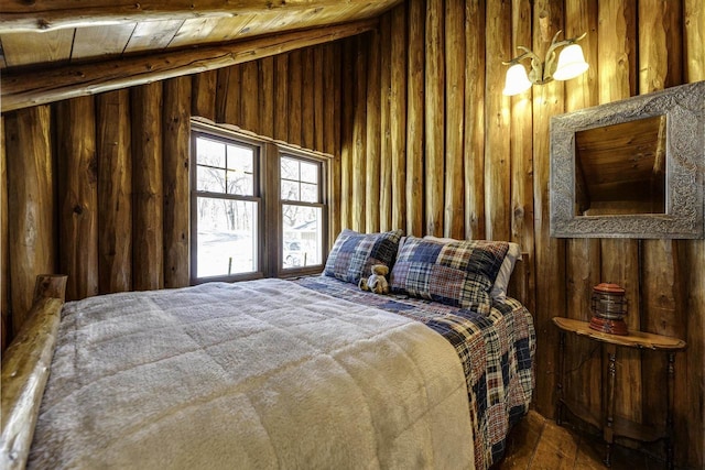 bedroom featuring vaulted ceiling, wooden ceiling, and wood walls