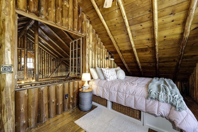 unfurnished bedroom with vaulted ceiling with beams, hardwood / wood-style flooring, and wooden ceiling