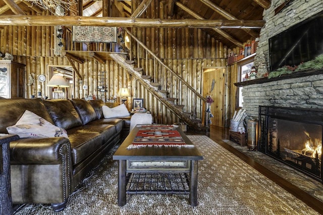 unfurnished living room with wood ceiling, beam ceiling, high vaulted ceiling, and a stone fireplace