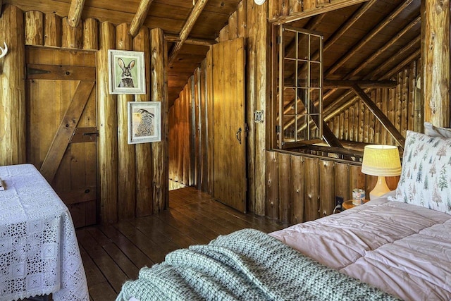 bedroom with dark hardwood / wood-style floors, wooden walls, wooden ceiling, and lofted ceiling with beams