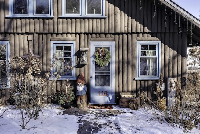 view of snow covered property entrance