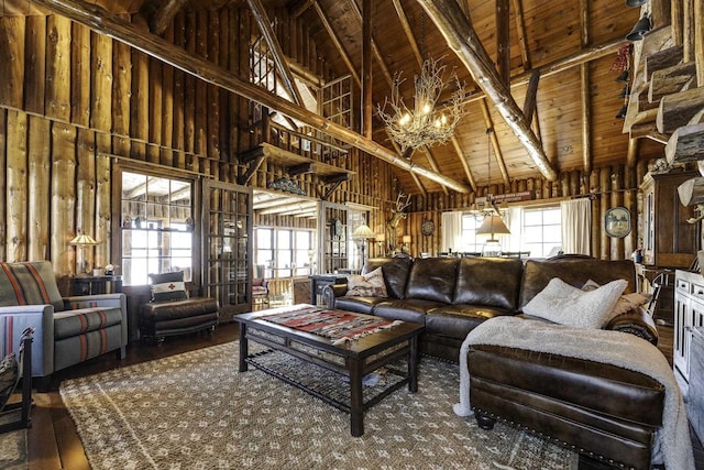 living room featuring plenty of natural light, high vaulted ceiling, wood-type flooring, wooden ceiling, and beamed ceiling