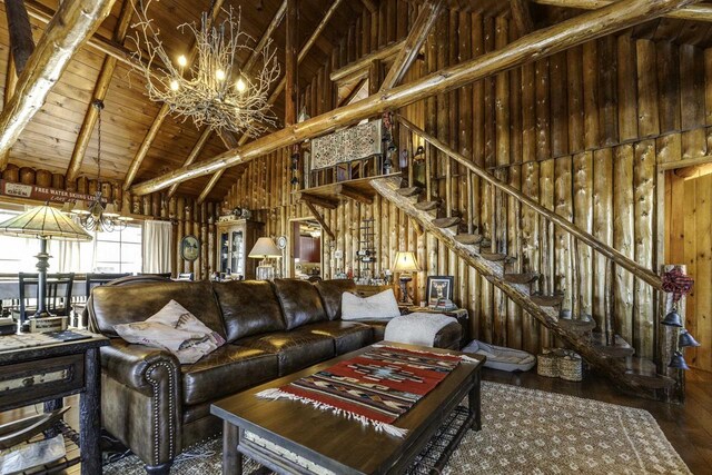 living room with wood ceiling, hardwood / wood-style floors, high vaulted ceiling, a notable chandelier, and beamed ceiling