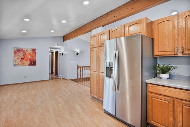 kitchen featuring lofted ceiling with beams, light wood-type flooring, and stainless steel fridge with ice dispenser