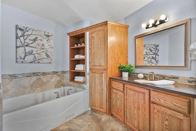 bathroom featuring vanity, a bath, and decorative backsplash