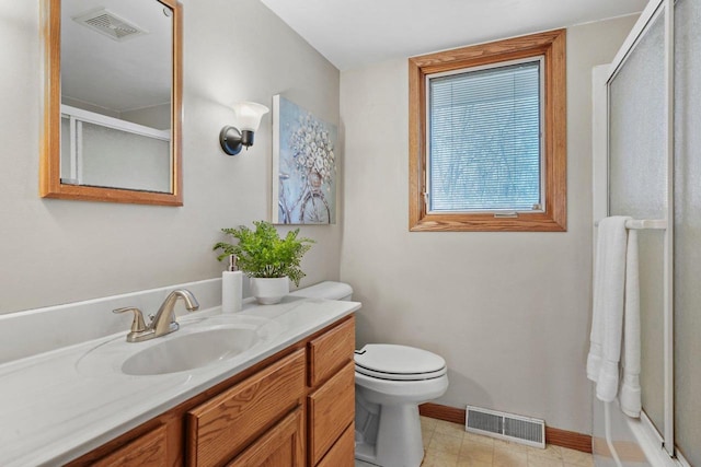 full bathroom with vanity, enclosed tub / shower combo, and toilet