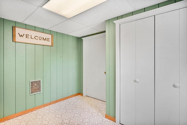 basement with a paneled ceiling