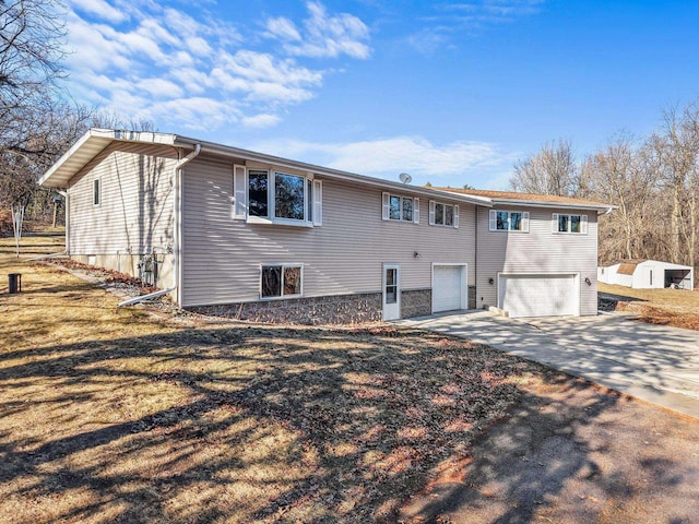 rear view of property featuring a garage