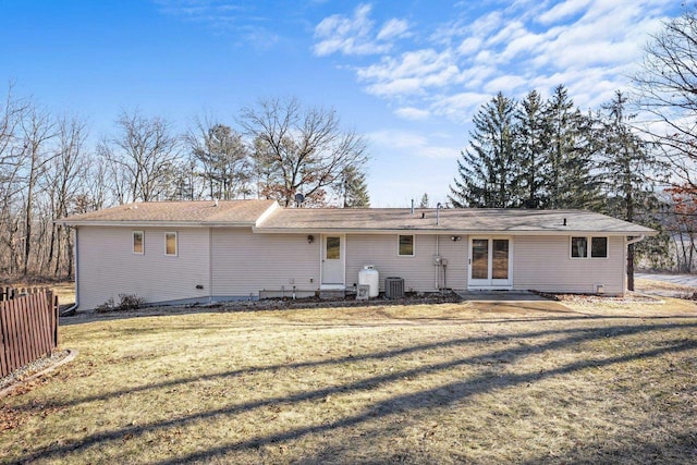 rear view of house with a lawn and central air condition unit