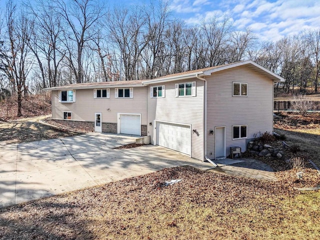 rear view of property with a garage