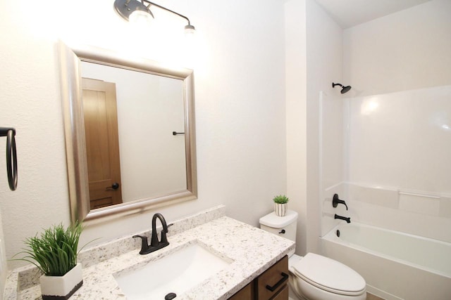 full bathroom featuring washtub / shower combination, vanity, and toilet