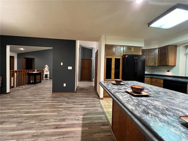 kitchen featuring black appliances and wood-type flooring