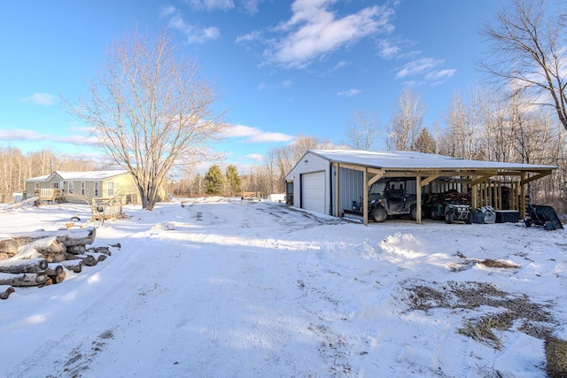 yard layered in snow featuring a garage and a carport