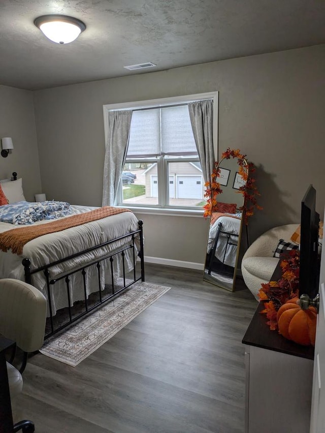 bedroom featuring dark hardwood / wood-style floors and a textured ceiling