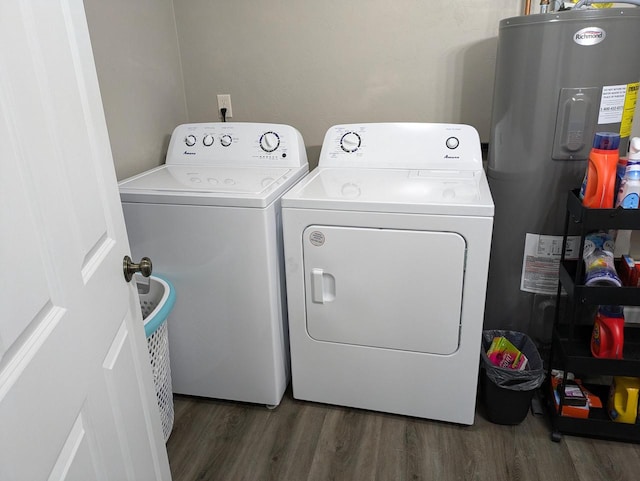 clothes washing area featuring water heater, dark hardwood / wood-style floors, and washing machine and clothes dryer