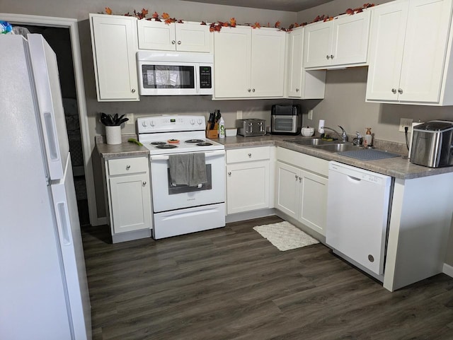 kitchen featuring white cabinetry, sink, dark hardwood / wood-style floors, and white appliances