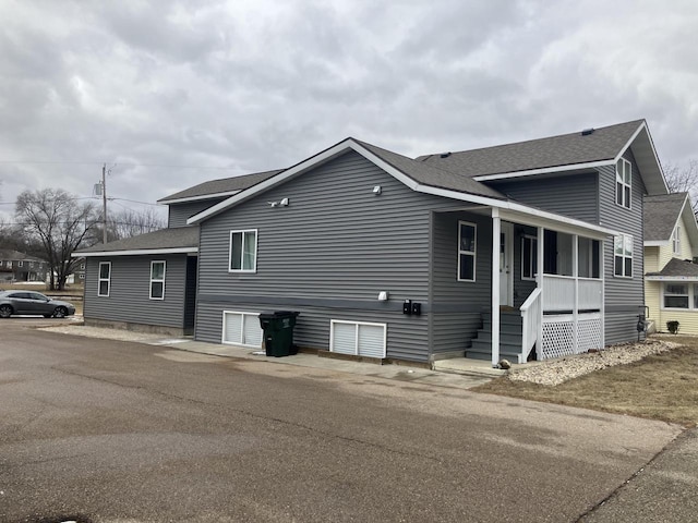 view of property exterior with covered porch