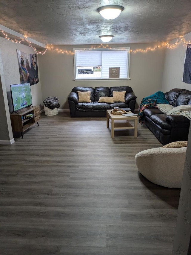 living room featuring dark hardwood / wood-style flooring and a textured ceiling