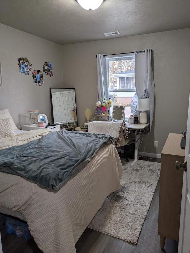 bedroom with dark hardwood / wood-style flooring