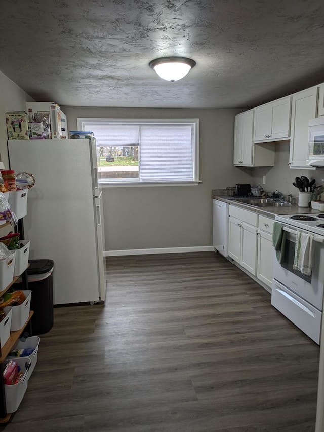 kitchen featuring white cabinetry, sink, dark hardwood / wood-style flooring, and white appliances