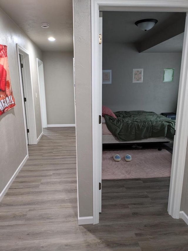 corridor with hardwood / wood-style flooring