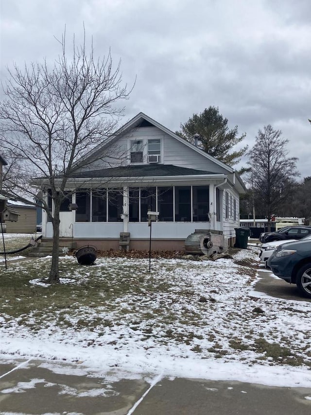 view of front of house with a sunroom