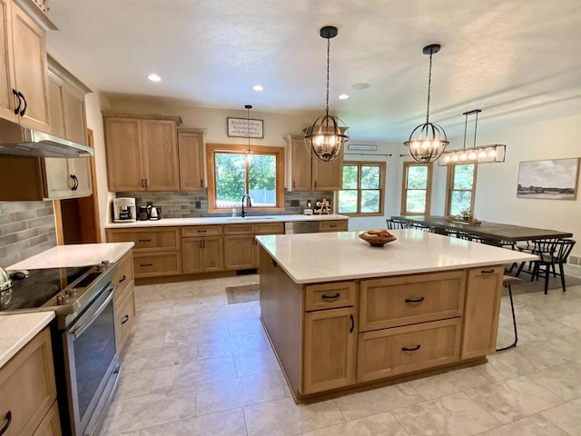 kitchen featuring a wealth of natural light, a center island, stainless steel appliances, decorative backsplash, and hanging light fixtures