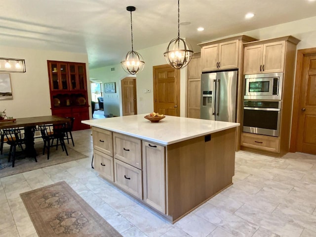 kitchen with a notable chandelier, a center island, hanging light fixtures, light brown cabinets, and stainless steel appliances